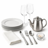 White dinner plates, wine glasses, cutlery, teapot, napkin and tealight for front of house