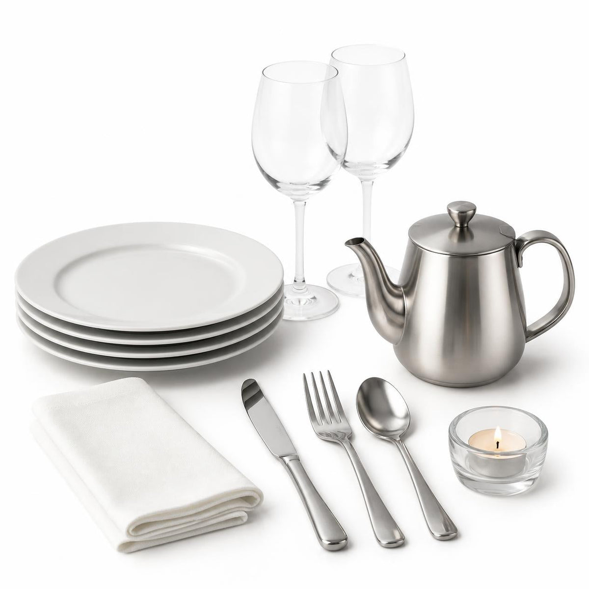 White dinner plates, wine glasses, cutlery, teapot, napkin and tealight for front of house